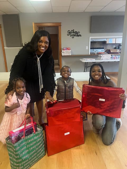 Families receiving gifts at the Romans 116 Church Christmas Giveaway (4)